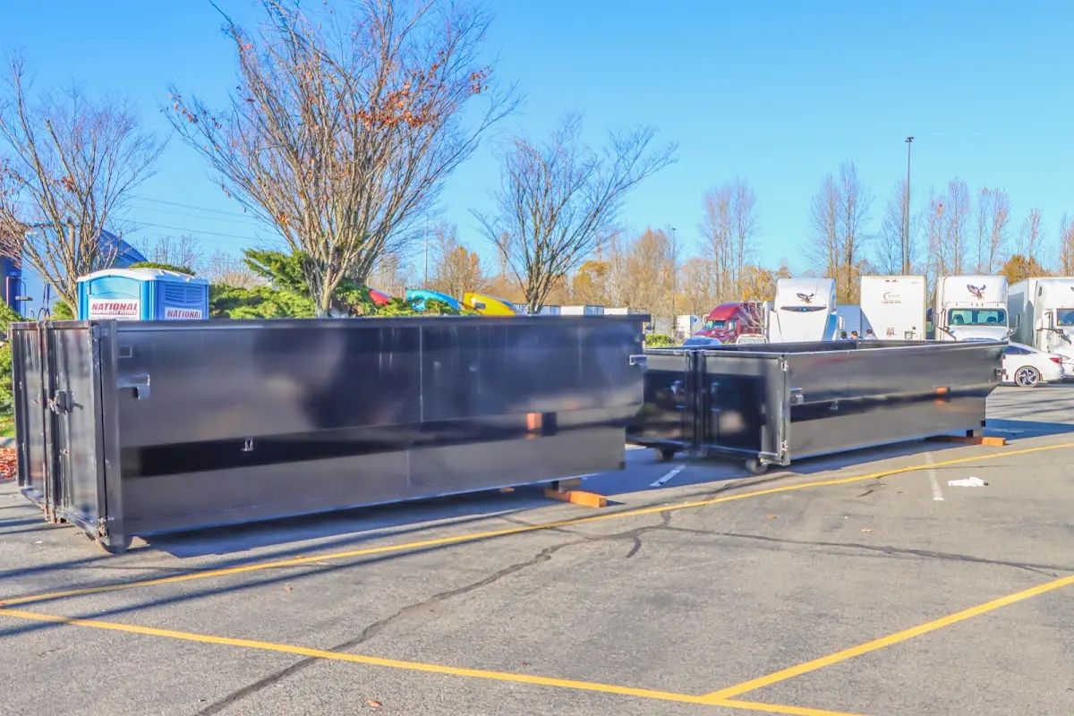 Professional dumpster rental service with roll-off container on residential driveway in Hornell